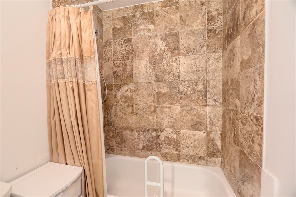 201 Stone Street Clinton, MA 01510 - Photo 36 of 42 a bathroom with a shower curtain and a sink