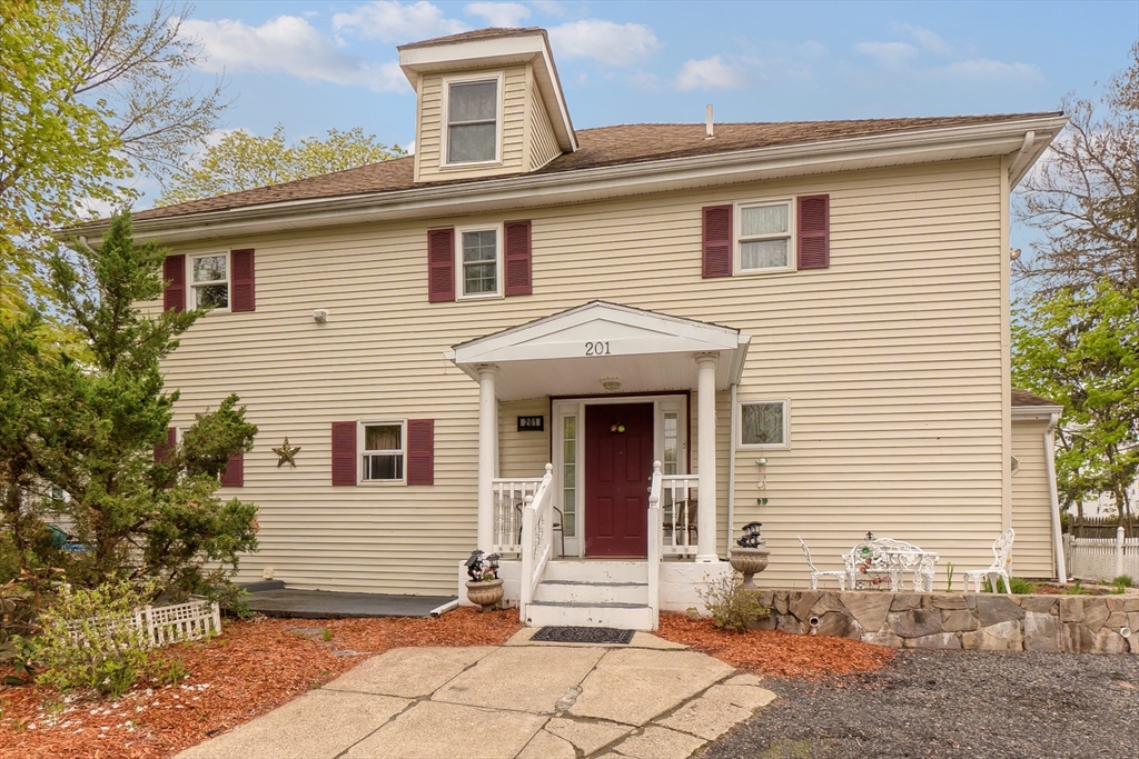 201 Stone Street Clinton, MA 01510 - Photo 42 of 42 a view of a house with a small yard and a large tree