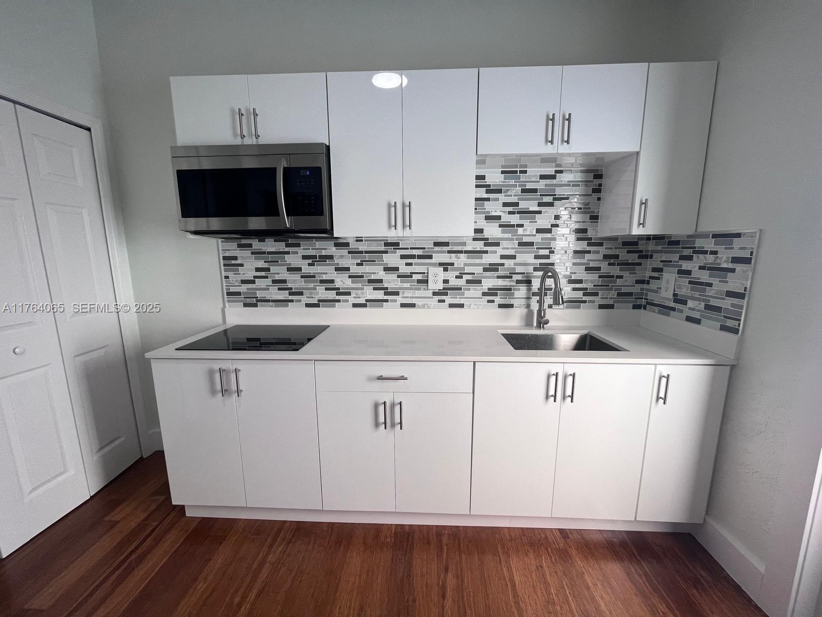22937 Southwest 9th Avenue, Unit 1 Miami, FL 33170 - Photo 6 of 19 a kitchen with stainless steel appliances a white stove top oven and a refrigerator