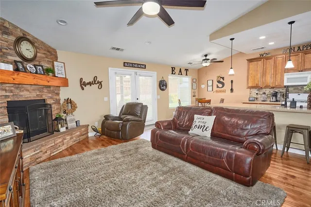 a dining room with furniture a chandelier and wooden floor