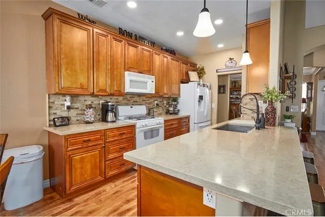 a kitchen with stainless steel appliances a stove sink and microwave