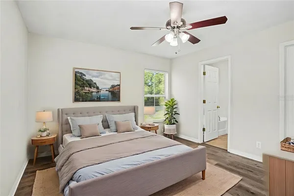 a bedroom with a large bed and a chandelier