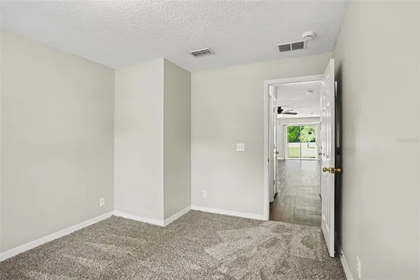 a view of a hallway to rooms