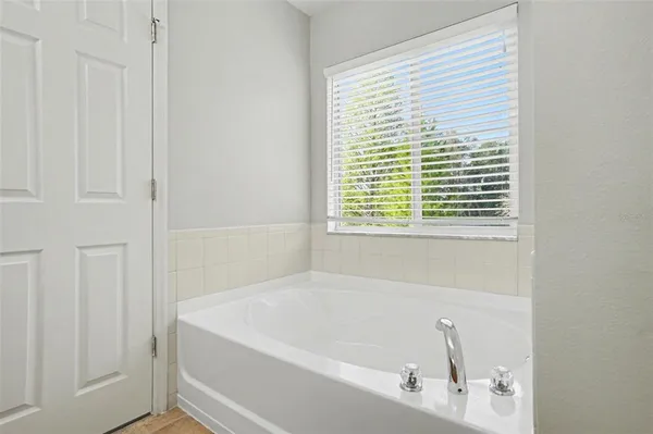 a white bath tub sitting next to a window