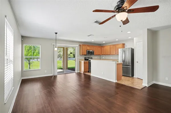 a view of a kitchen with an empty space and a window