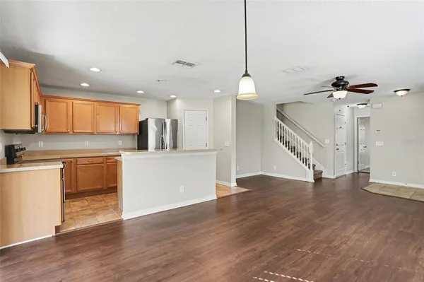 a view of a kitchen with a sink cabinets and wooden floor