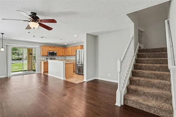 a view of empty room with wooden floor and window