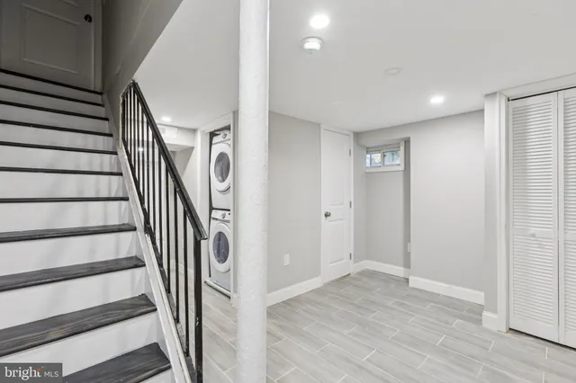 a view of a hallway with wooden floor and entryway