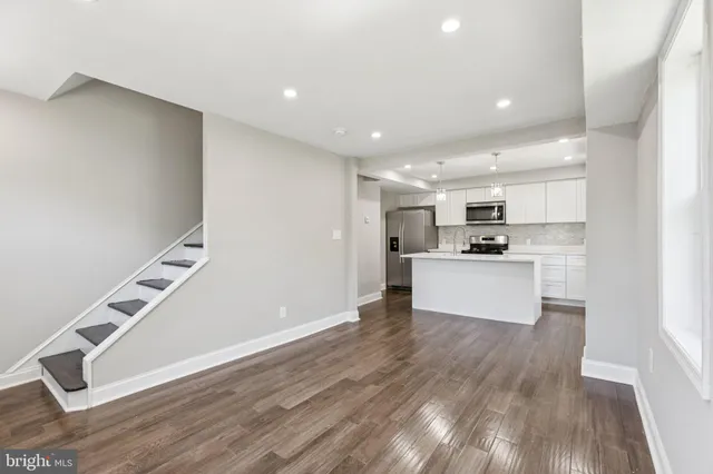 a view of kitchen with wooden floor and electronic appliances