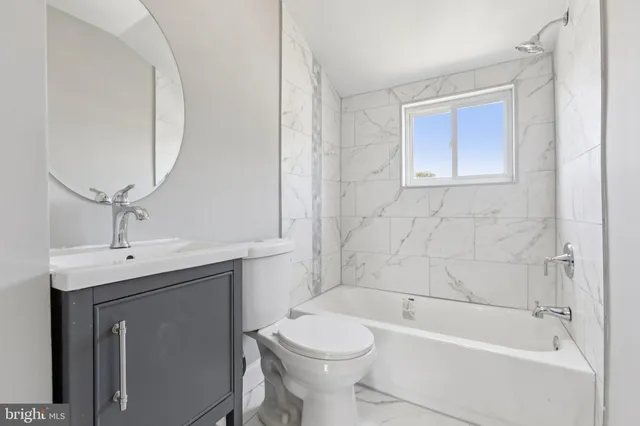 a bathroom with a toilet and a bathtub