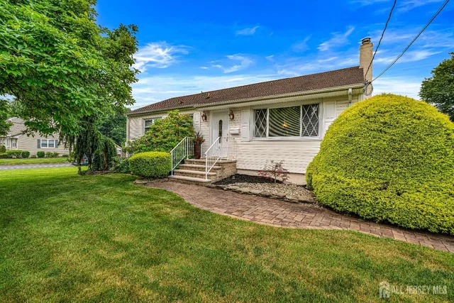 a view of backyard with a barn and large trees