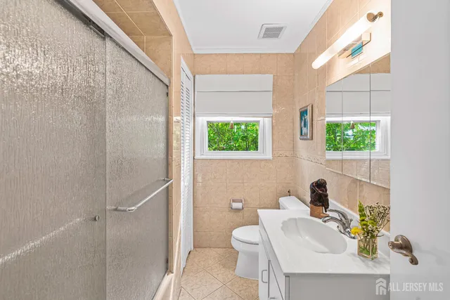 a bathroom with a sink a toilet and shower curtain