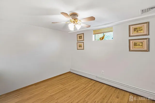 a view of a big room with wooden floor and windows in a room