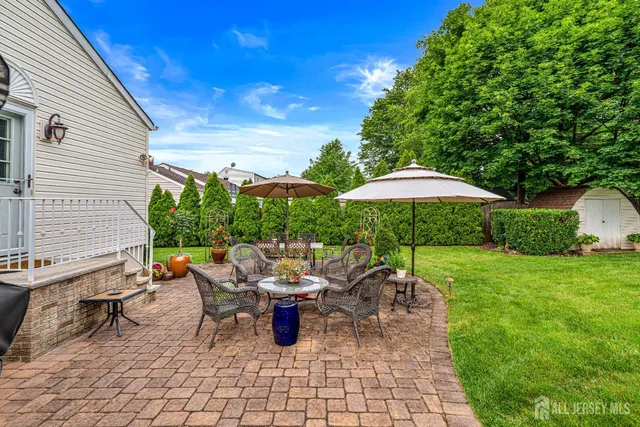 a view of a patio with table and chairs under an umbrella
