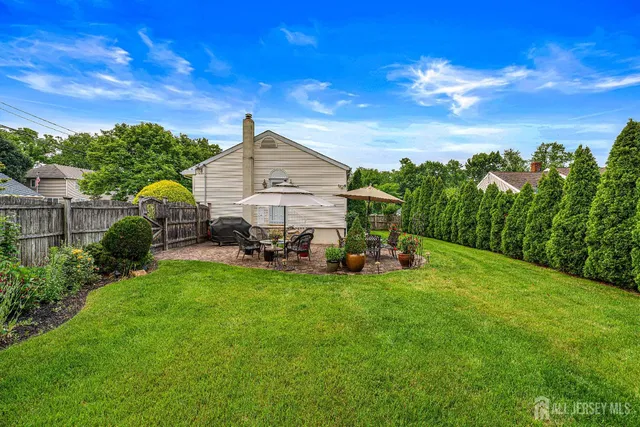 a view of a house with backyard porch and sitting area