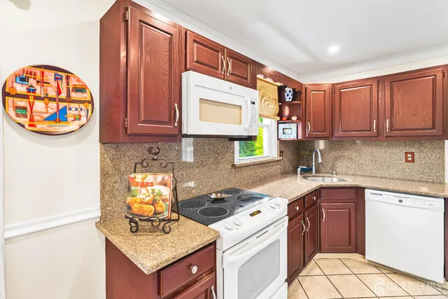 a kitchen with a stove a sink and a window