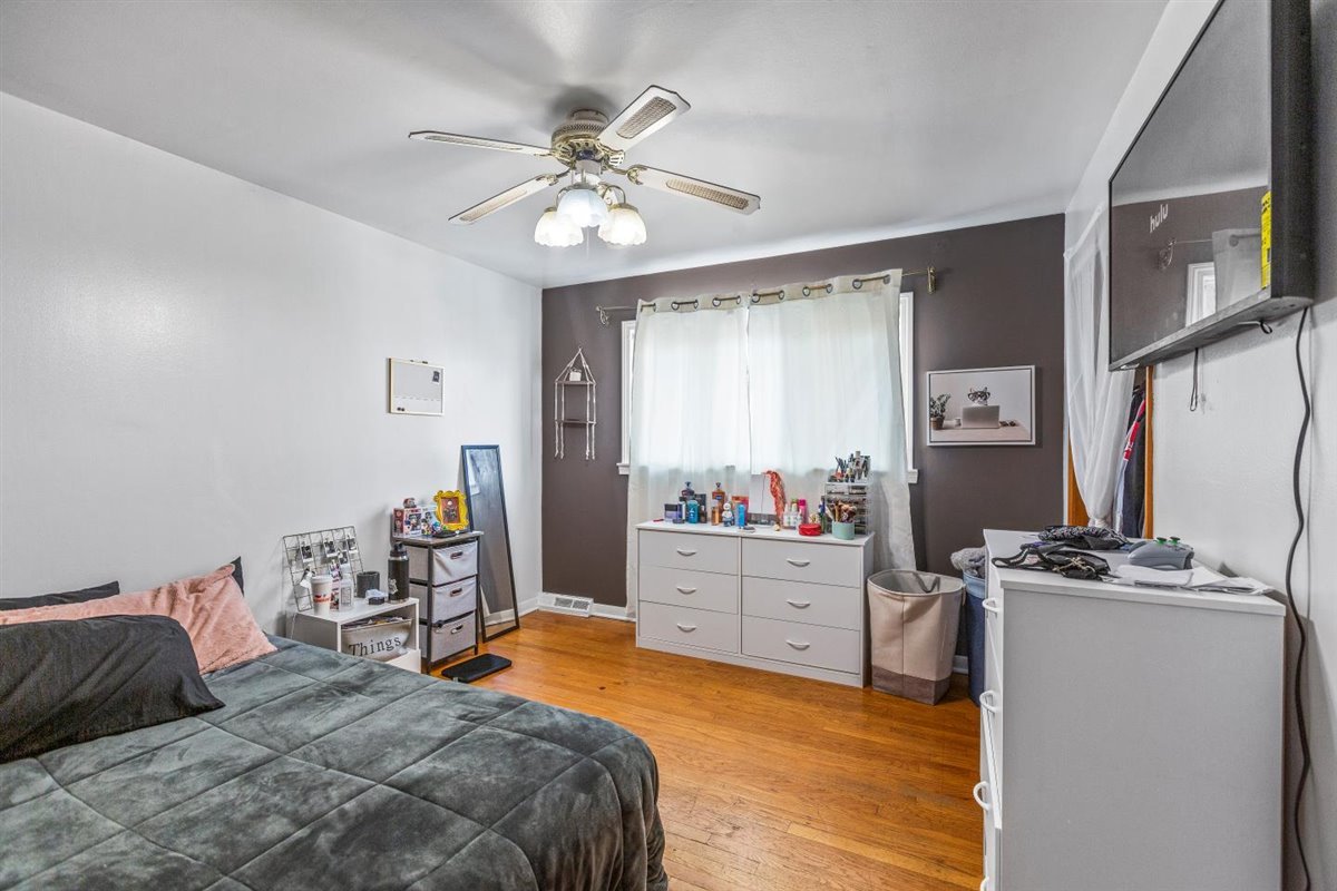 10619 Mason Avenue Chicago Ridge, IL 60415 - Photo 14 of 29 a bedroom with a bed and a chandelier