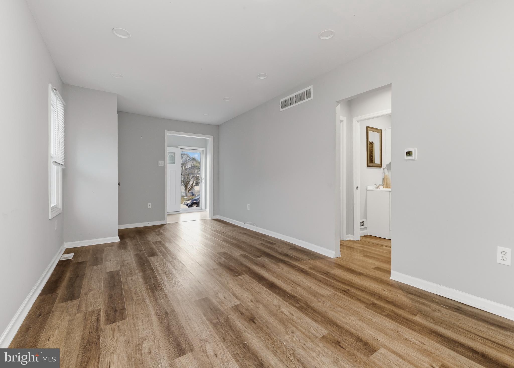 206 West 5th Avenue Runnemede, NJ 08078 - Photo 3 of 14 a view of empty room with wooden floor and window