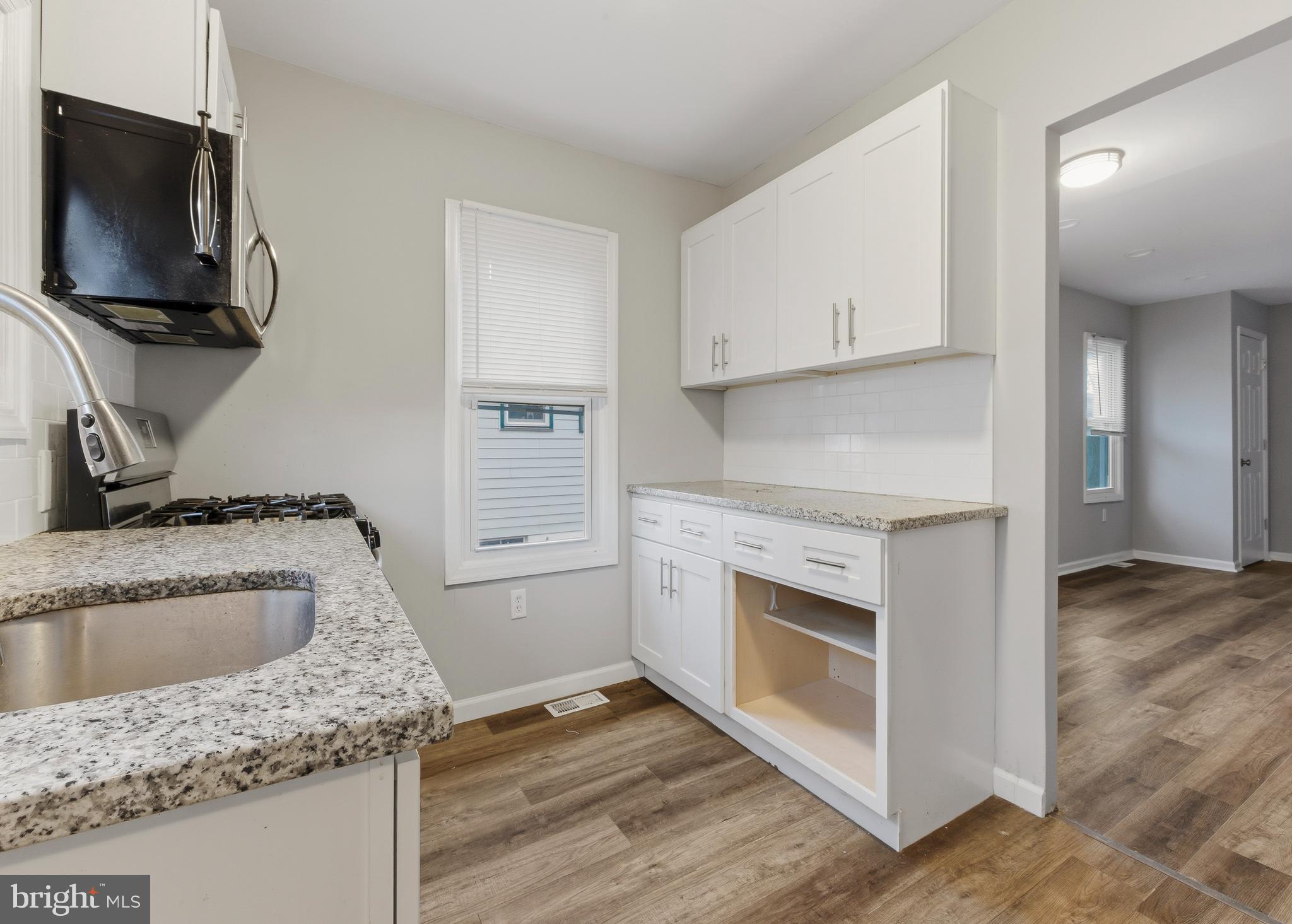 206 West 5th Avenue Runnemede, NJ 08078 - Photo 6 of 14 a kitchen with granite countertop a sink and a stove top oven