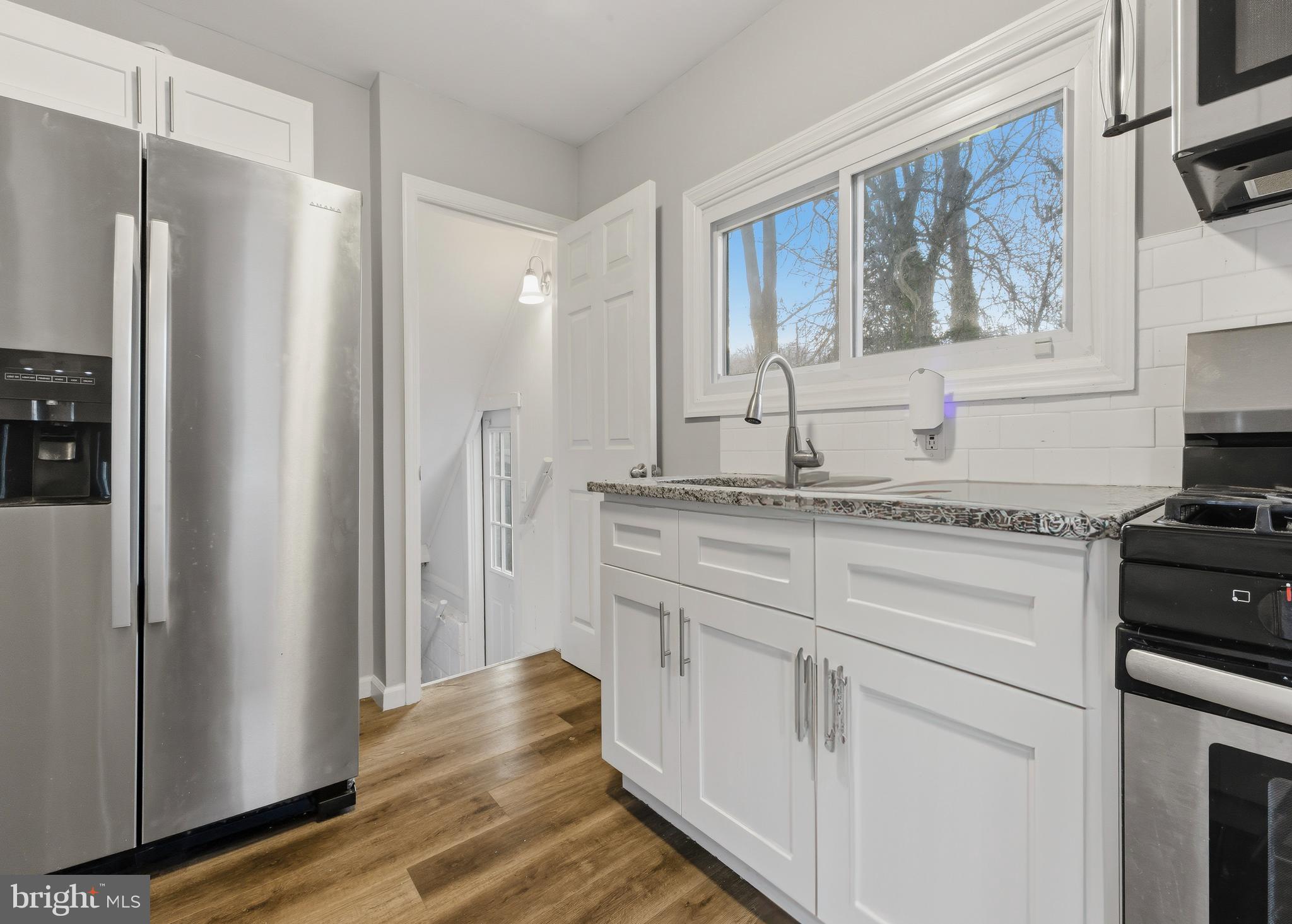 206 West 5th Avenue Runnemede, NJ 08078 - Photo 7 of 14 a kitchen with white cabinets and a refrigerator