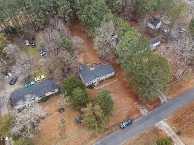 an aerial view of a house with a yard