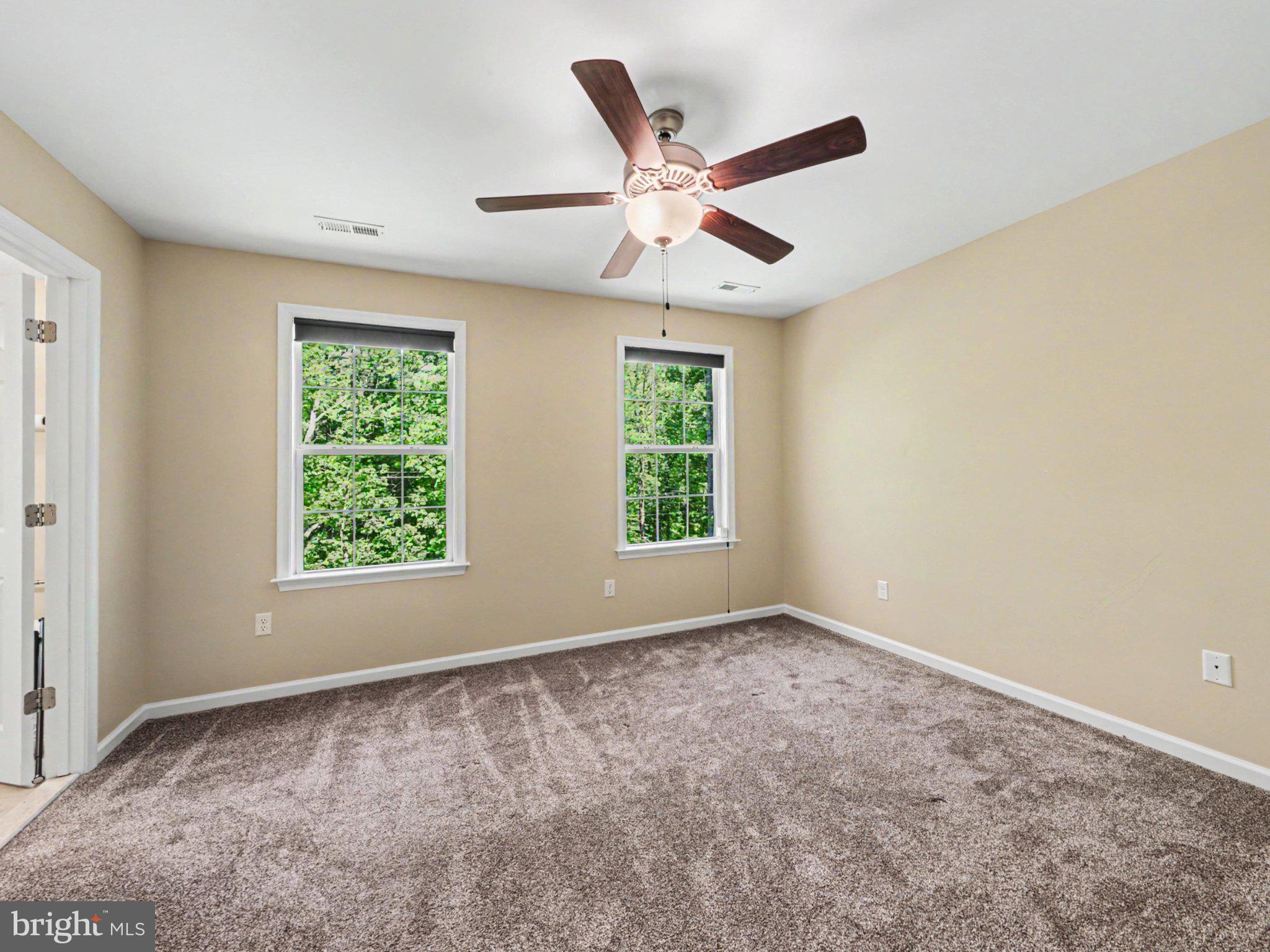 9811 Catharpin Road Spotsylvania, VA 22551 - Photo 17 of 30 an empty room with windows and fan