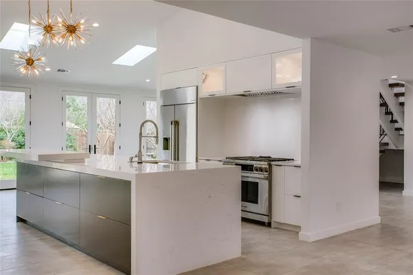a kitchen with stainless steel appliances a sink stove and cabinets