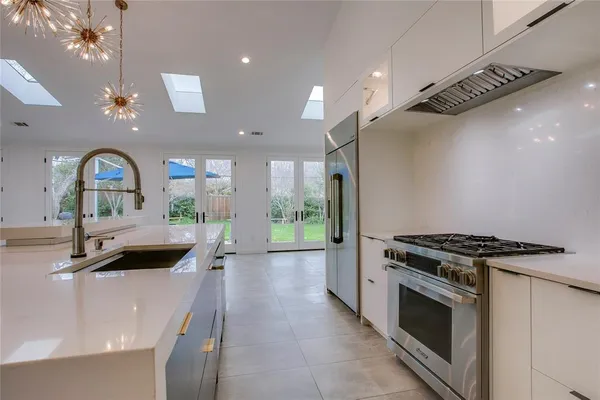 a kitchen with granite countertop a stove and a sink