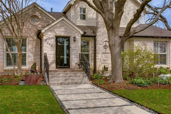 a front view of a house with garden