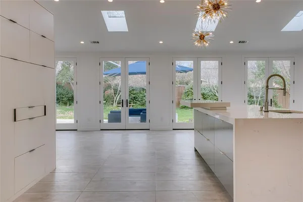 a view of a kitchen with a sink and a large window