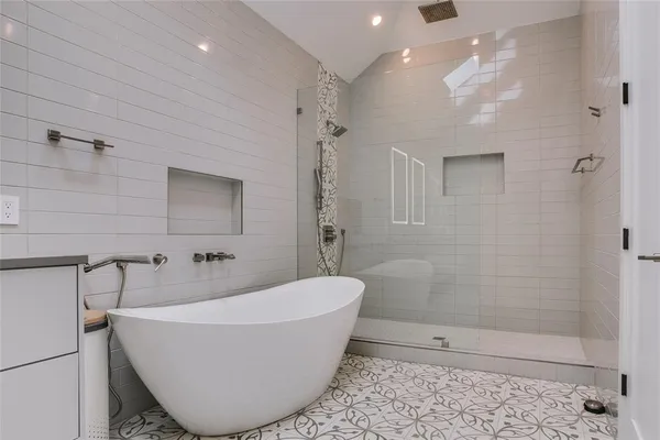 a bathroom with a bathtub and shower
