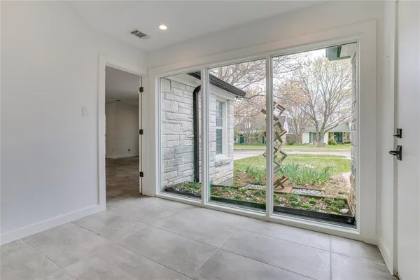 an empty room with large windows