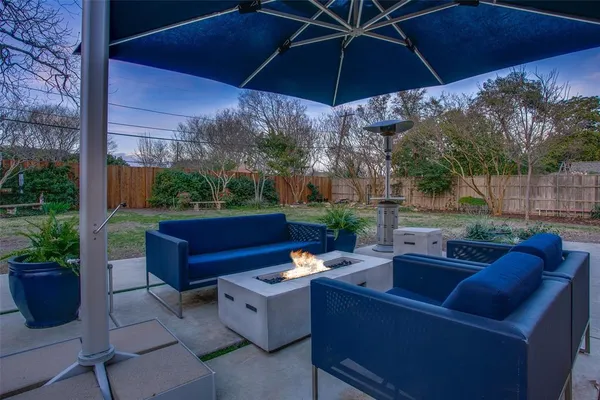 a view of a patio with couches under an umbrella