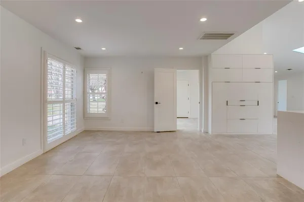 an empty room with windows and closet
