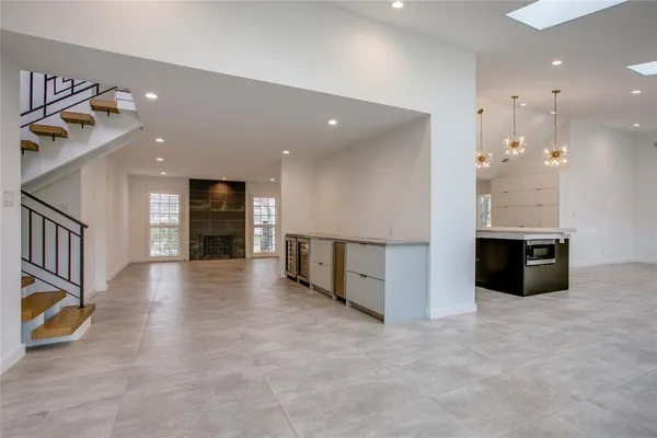 a view of a kitchen with a sink and a large mirror