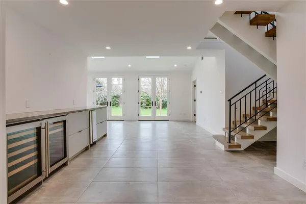 a large white kitchen with a large window