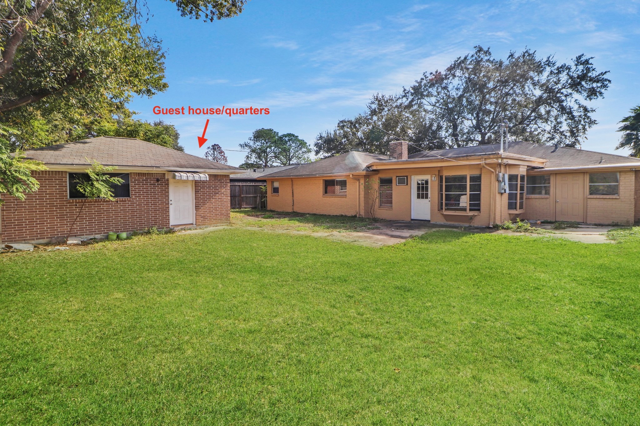 5554 Beechnut Street Houston, TX 77096 - Photo 27 of 30 a view of a house with a backyard and a patio
