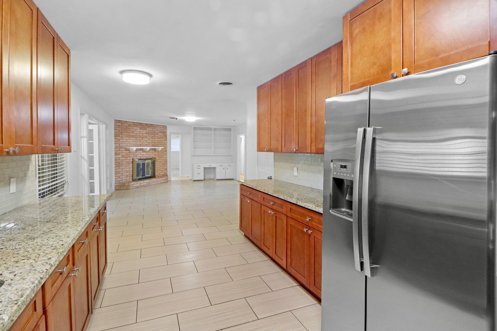 5554 Beechnut Street Houston, TX 77096 - Photo 9 of 30 a large kitchen with stainless steel appliances granite countertop a refrigerator and a sink