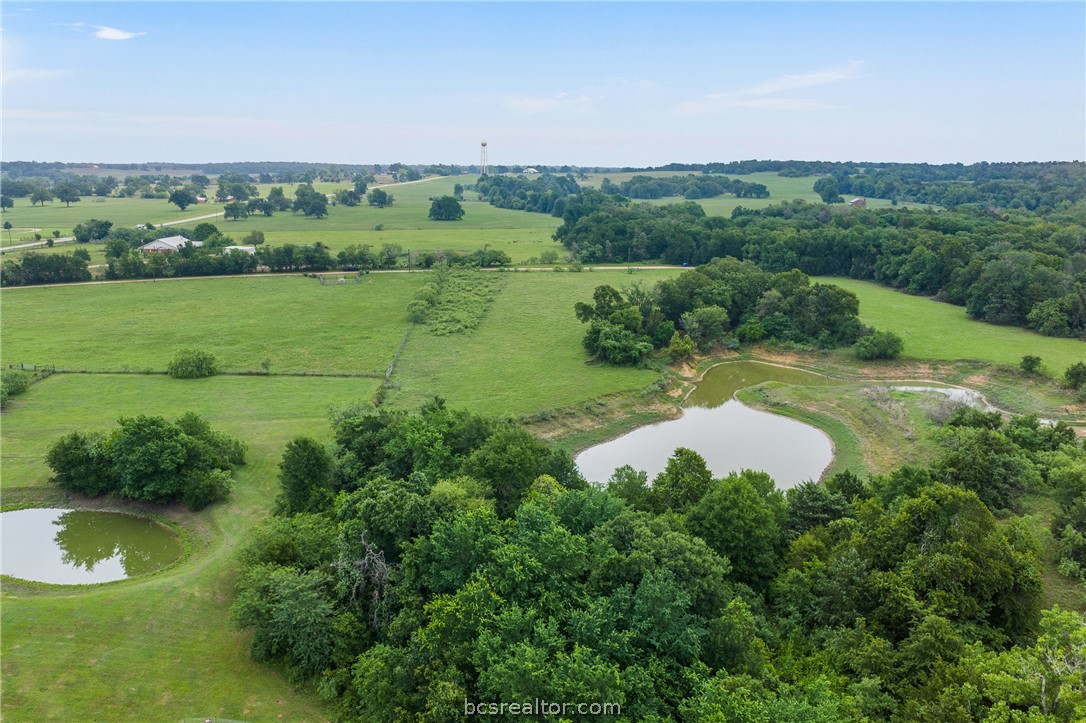 2095 & Prairie Cameron, TX 76520 - Photo 12 of 27 a view of a lush green outdoor space with a swimming pool and valleys in the background