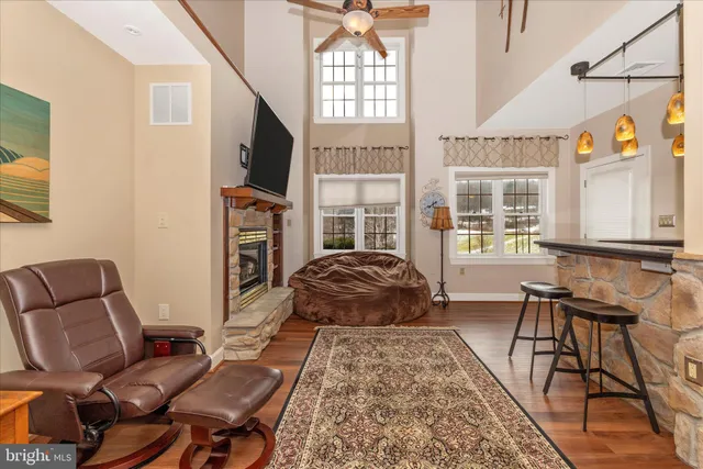 a living room with furniture flat screen tv and a fireplace