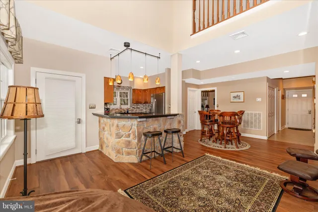 a kitchen with stainless steel appliances granite countertop wooden cabinets and a sink