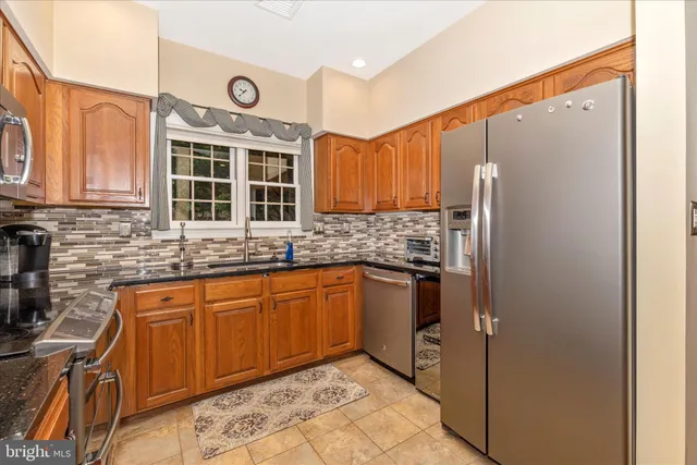 a kitchen with stainless steel appliances a stove sink and microwave