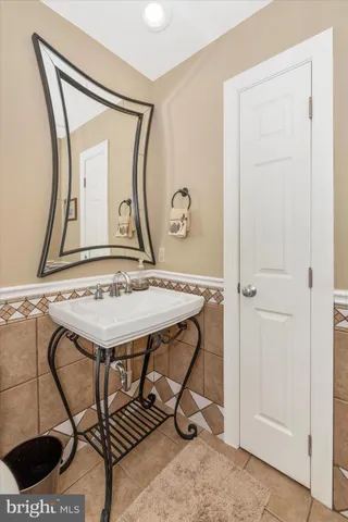 a bathroom with a granite countertop sink a mirror and a shower