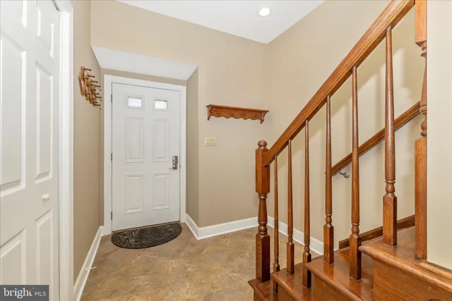 a view of an entryway with hardwood floor and stairs