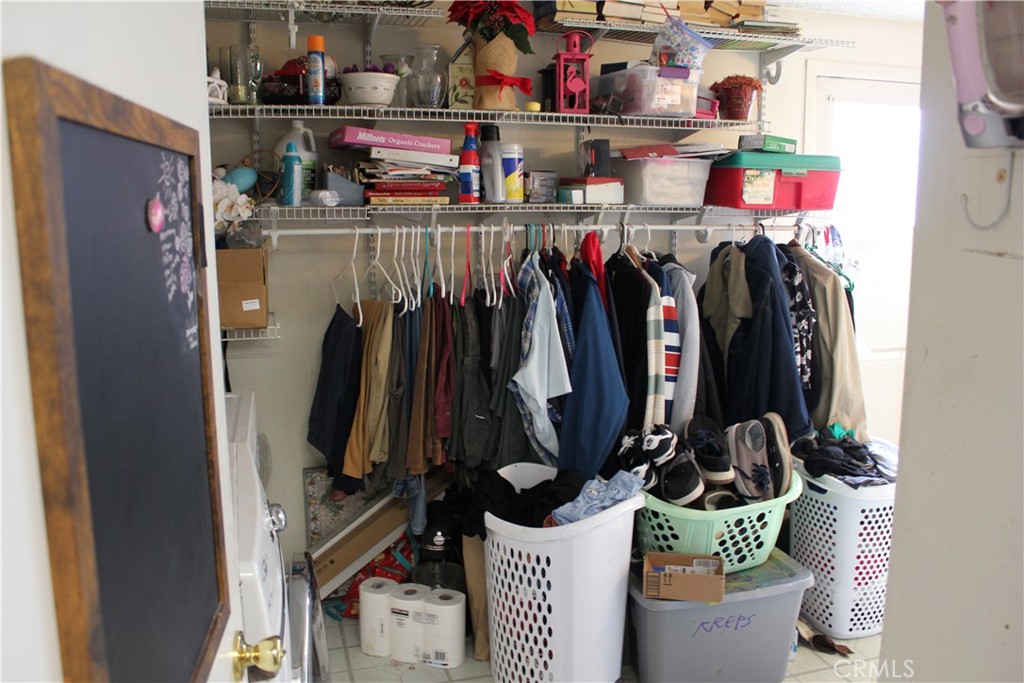 5911 Green Valley Road Riverside, CA 92504 - Photo 19 of 24 a view of walk in closet with clothes and shoes