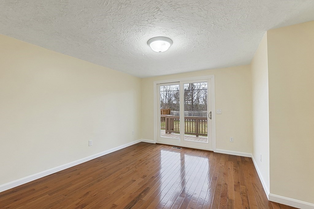 32 Elaine Street Webster, MA 01570 - Photo 16 of 42 an empty room with wooden floor and windows