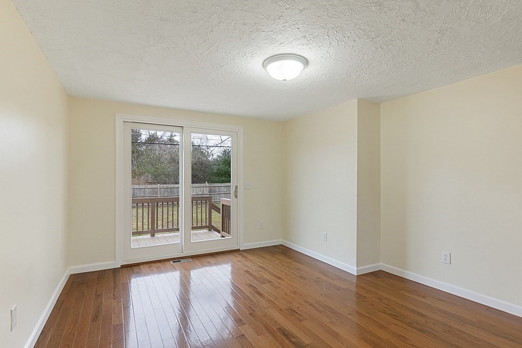 32 Elaine Street Webster, MA 01570 - Photo 17 of 42 an empty room with wooden floor and windows