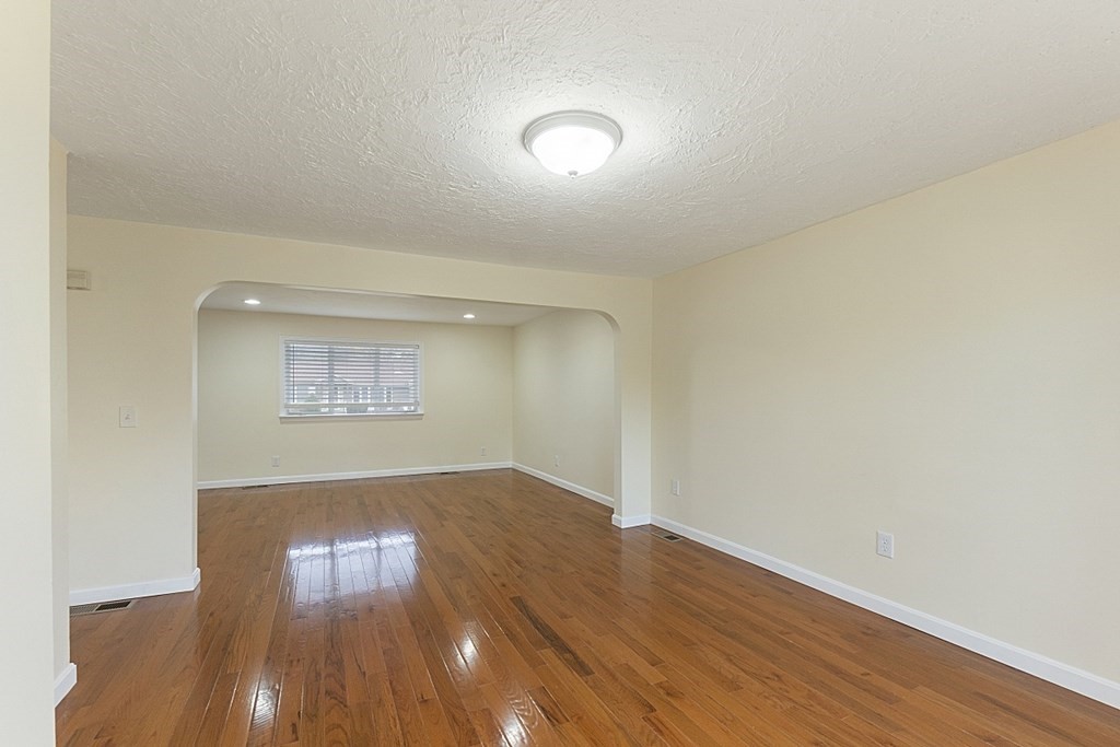 32 Elaine Street Webster, MA 01570 - Photo 18 of 42 an empty room with wooden floor and windows