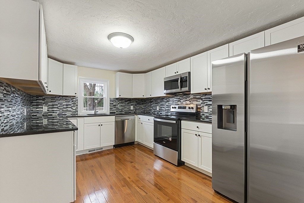 32 Elaine Street Webster, MA 01570 - Photo 19 of 42 a kitchen with a refrigerator stove top oven and sink