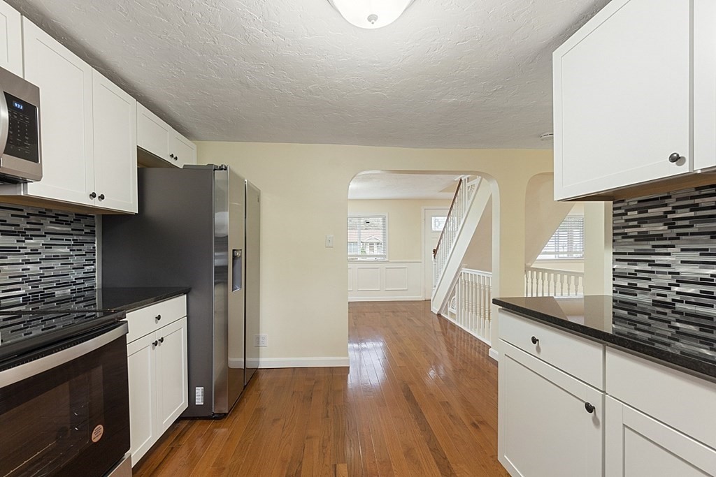 32 Elaine Street Webster, MA 01570 - Photo 21 of 42 a kitchen with granite countertop white cabinets and white appliances
